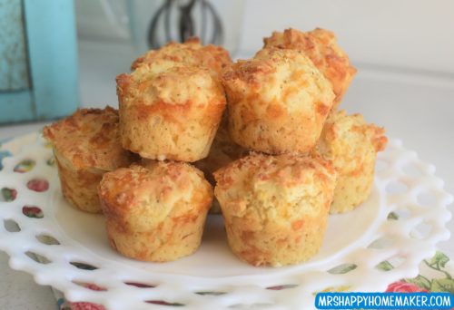 Cracked pepper cheddar muffins on a milk glass plate