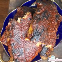Baby back ribs on an oval blue platter