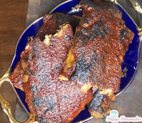 Baby back ribs on an oval blue platter