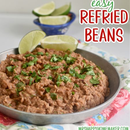 Easy homemade refried beans in a round silver dish on a floral tea towel