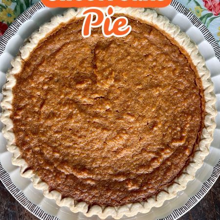 Sweet Potato Pie in a white dish with a blue floral towel next to it