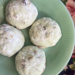 Pistachio Polvorones Cookies on a jadeite plate