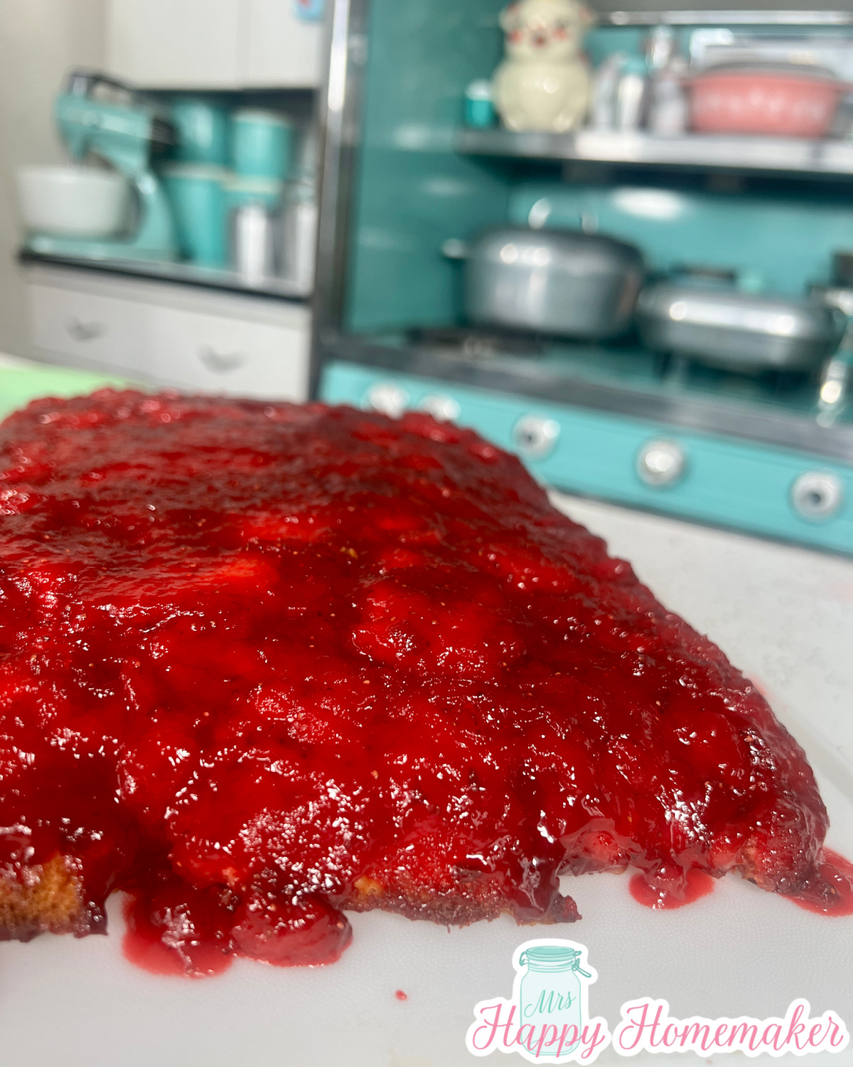 Strawberry Upside Down cake with a blue stove in the background