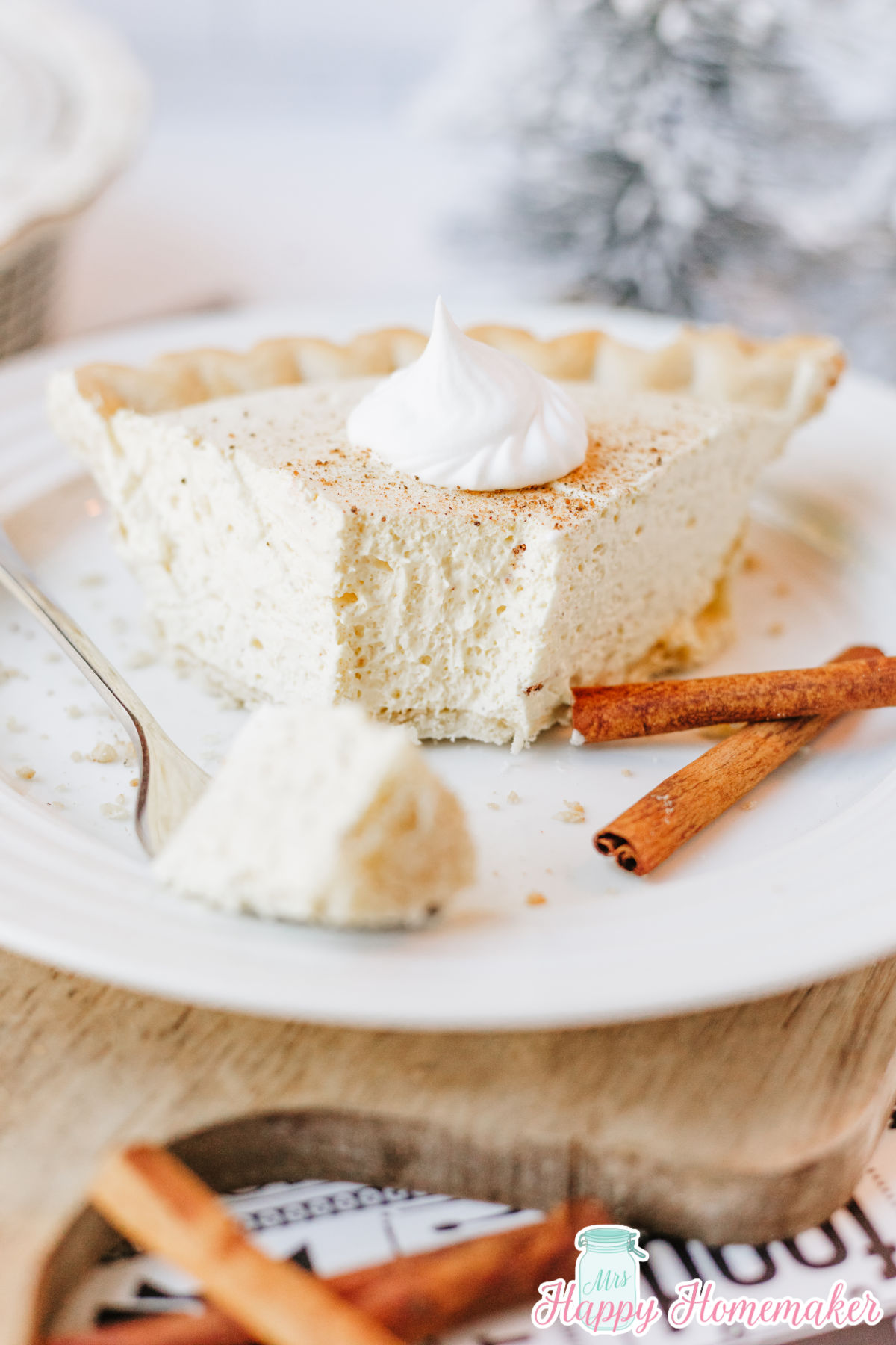 eggnog pie slice on a white plate with a bite sitting on a fork beside it