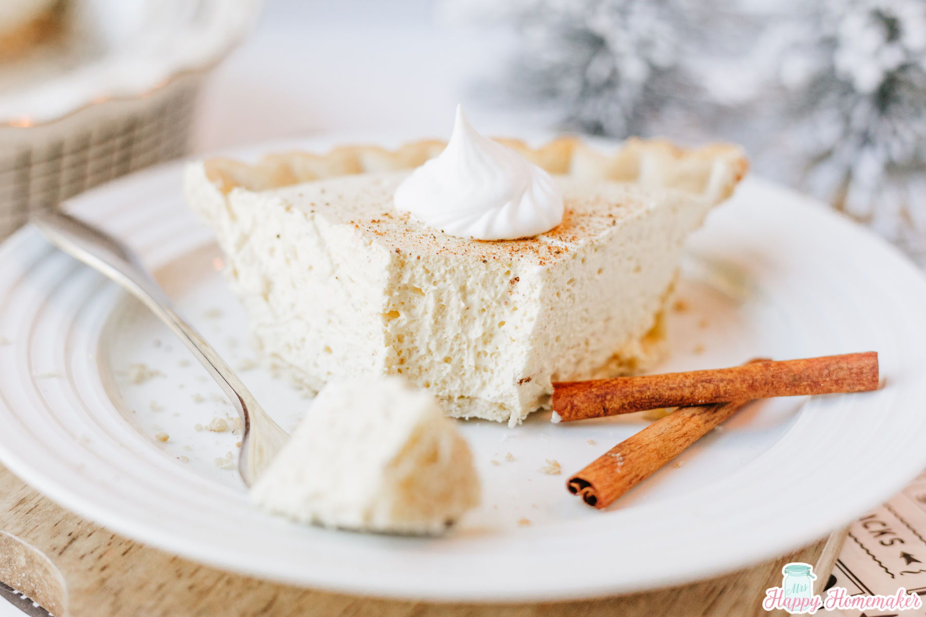 eggnog pie slice on a white plate with a bite sitting on a fork beside it