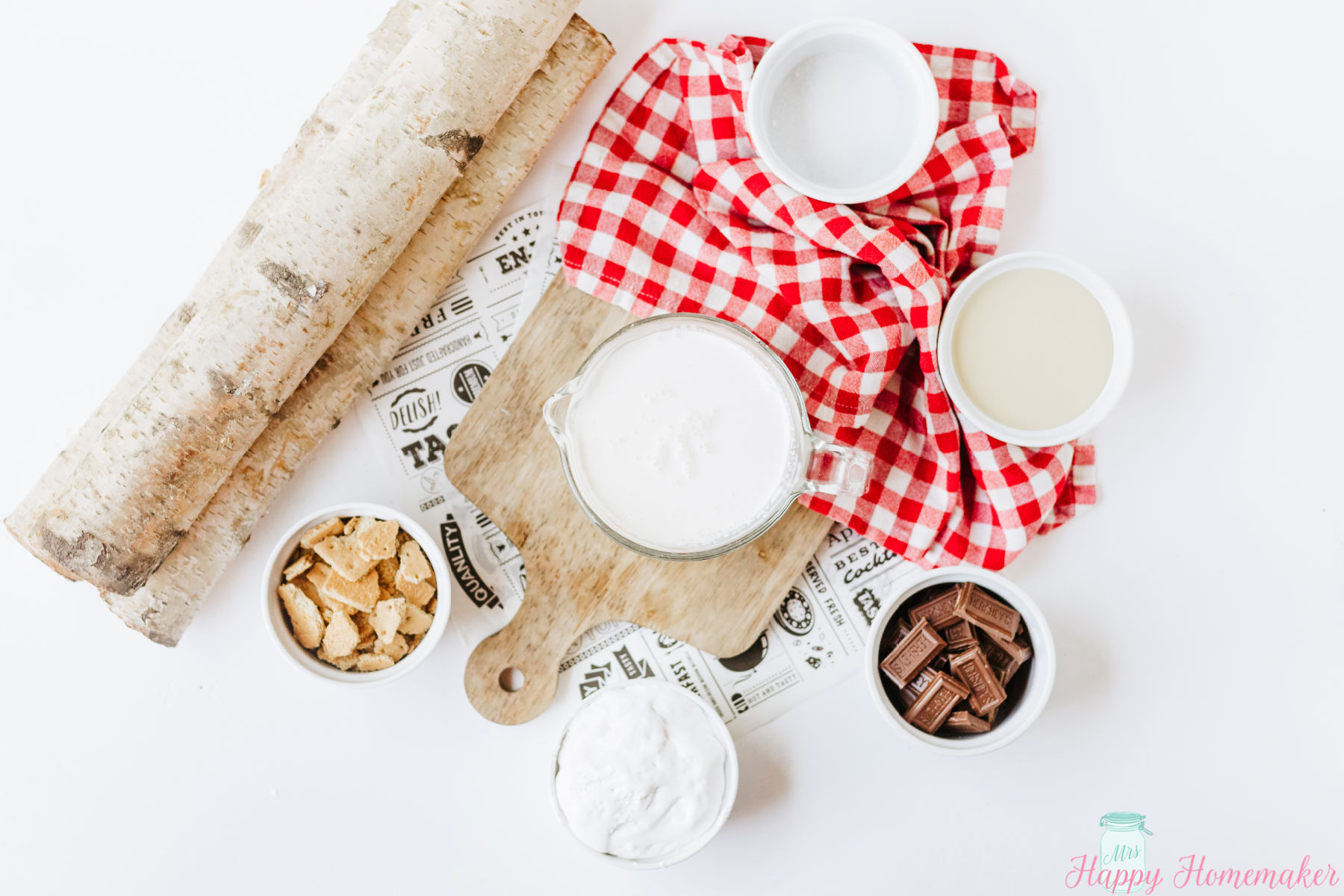 smores ice cream ingredients layed out in small bowls on a white counter