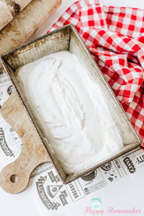 smores ice cream being layered in a loaf pan