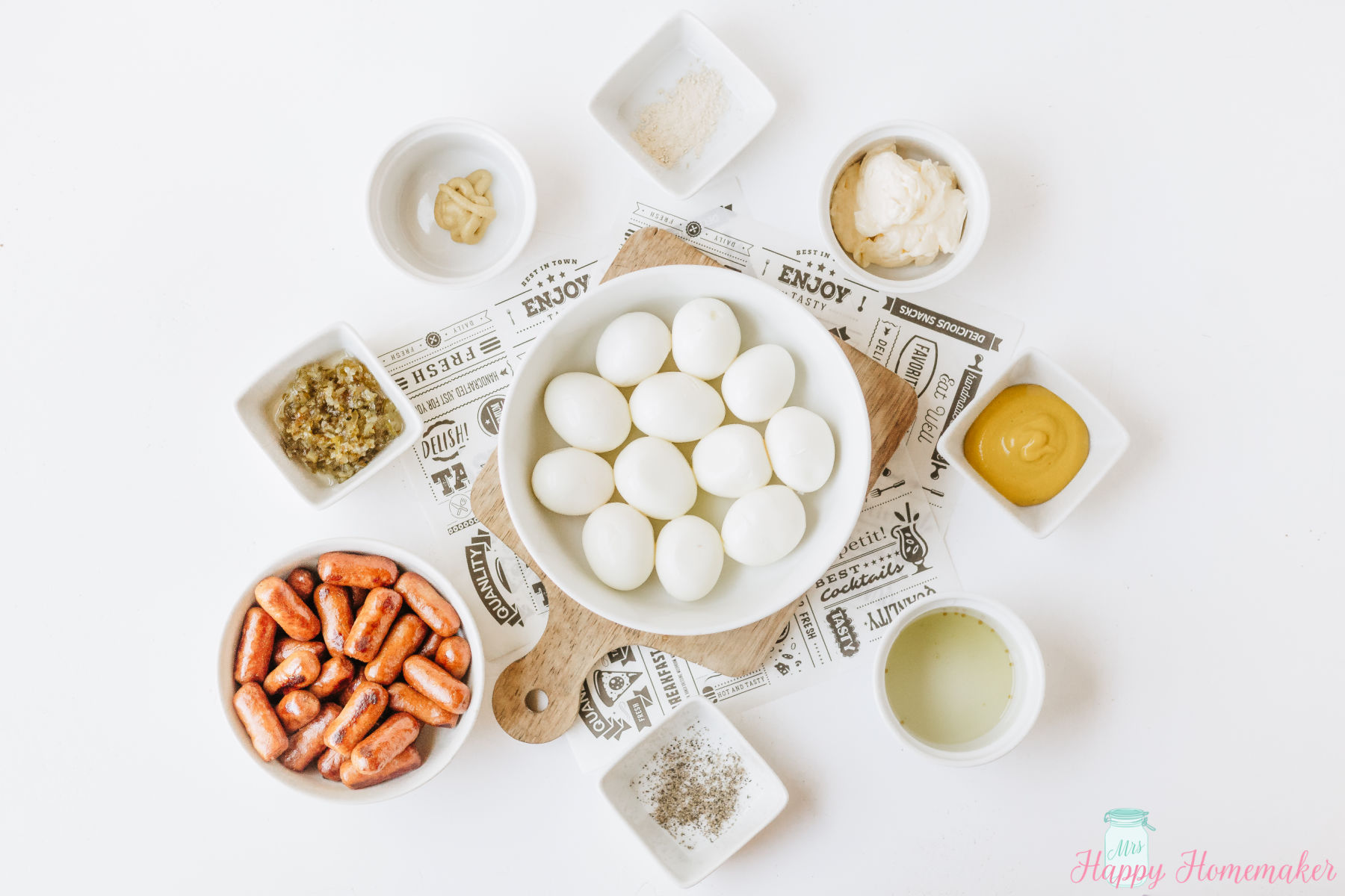 Hot Dog Deviled Eggs ingredients laid out in small containers on a white counter