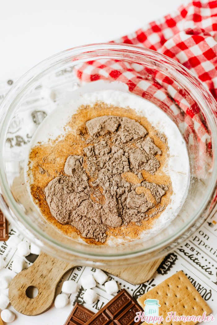 pudding mix and milk being mixed in a clear bowl