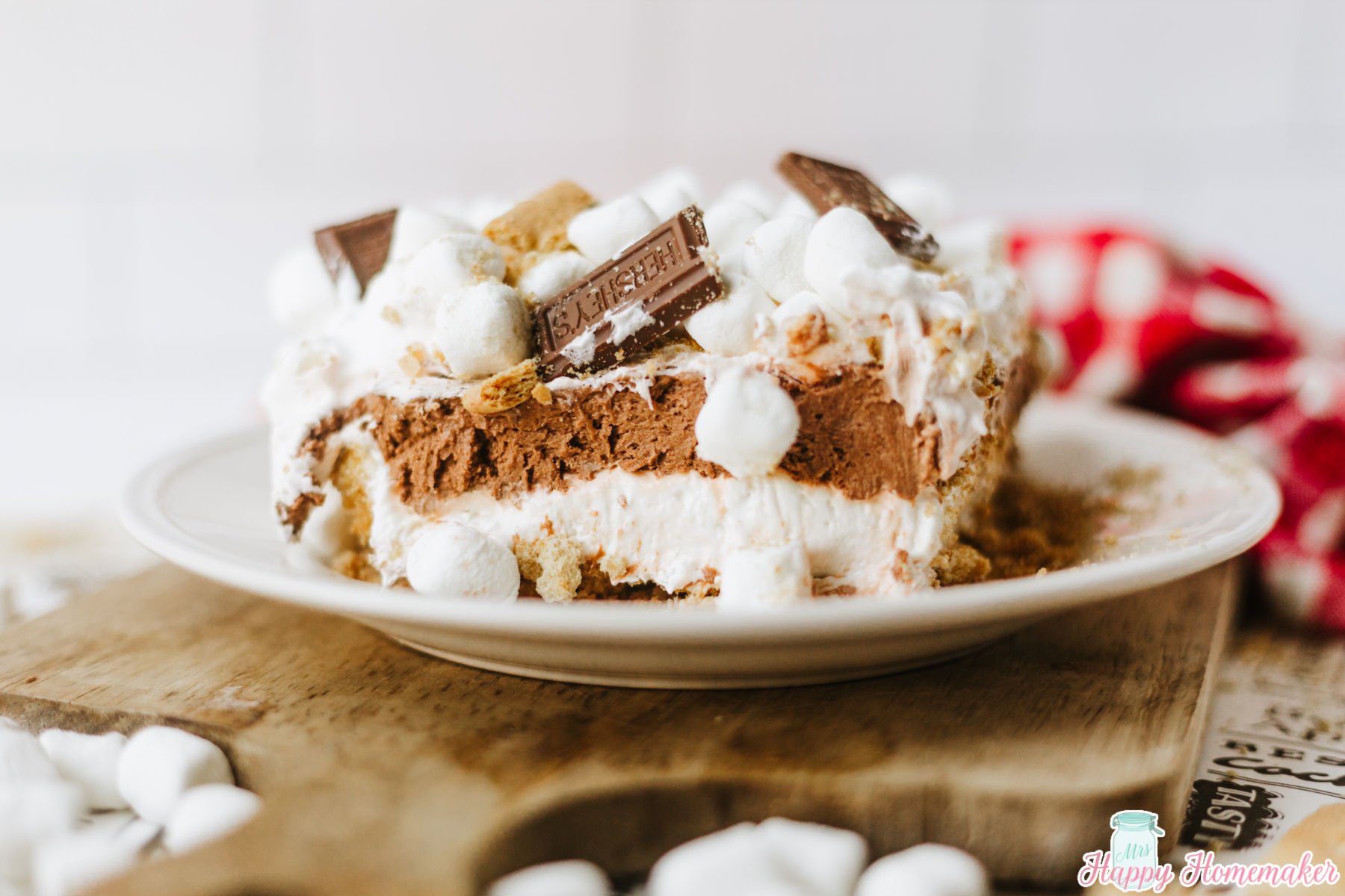 smores lasagna sliced in a square and served on a white plate