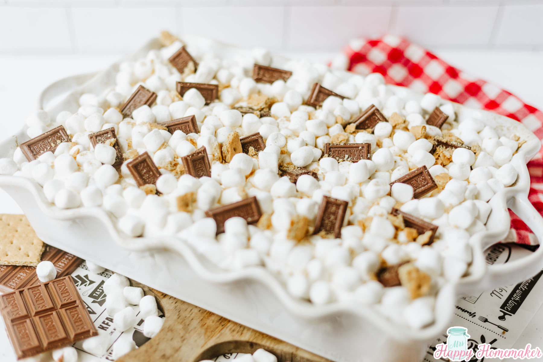 s'mores lasagna in a white 9x13 casserole dish