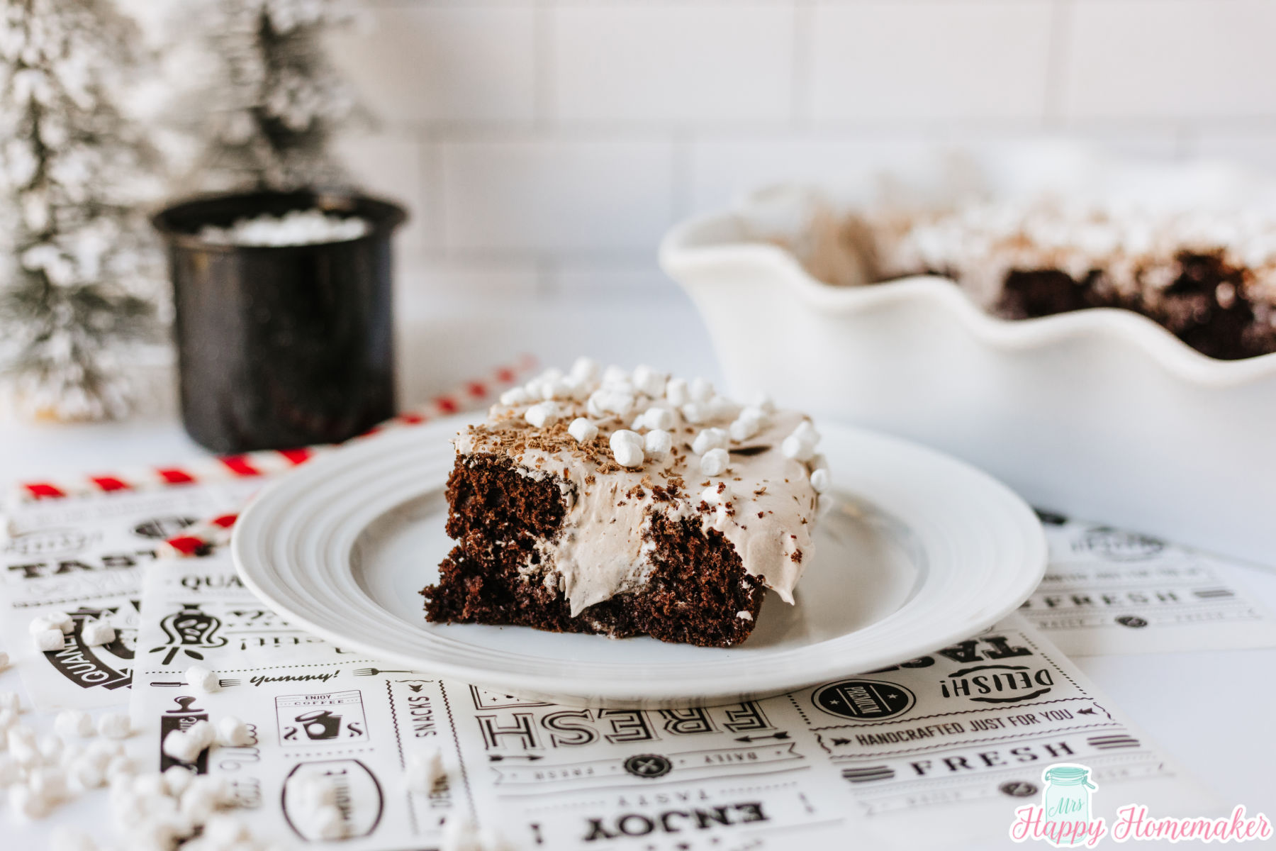 a slice of hot cocoa poke cake on a white plate
