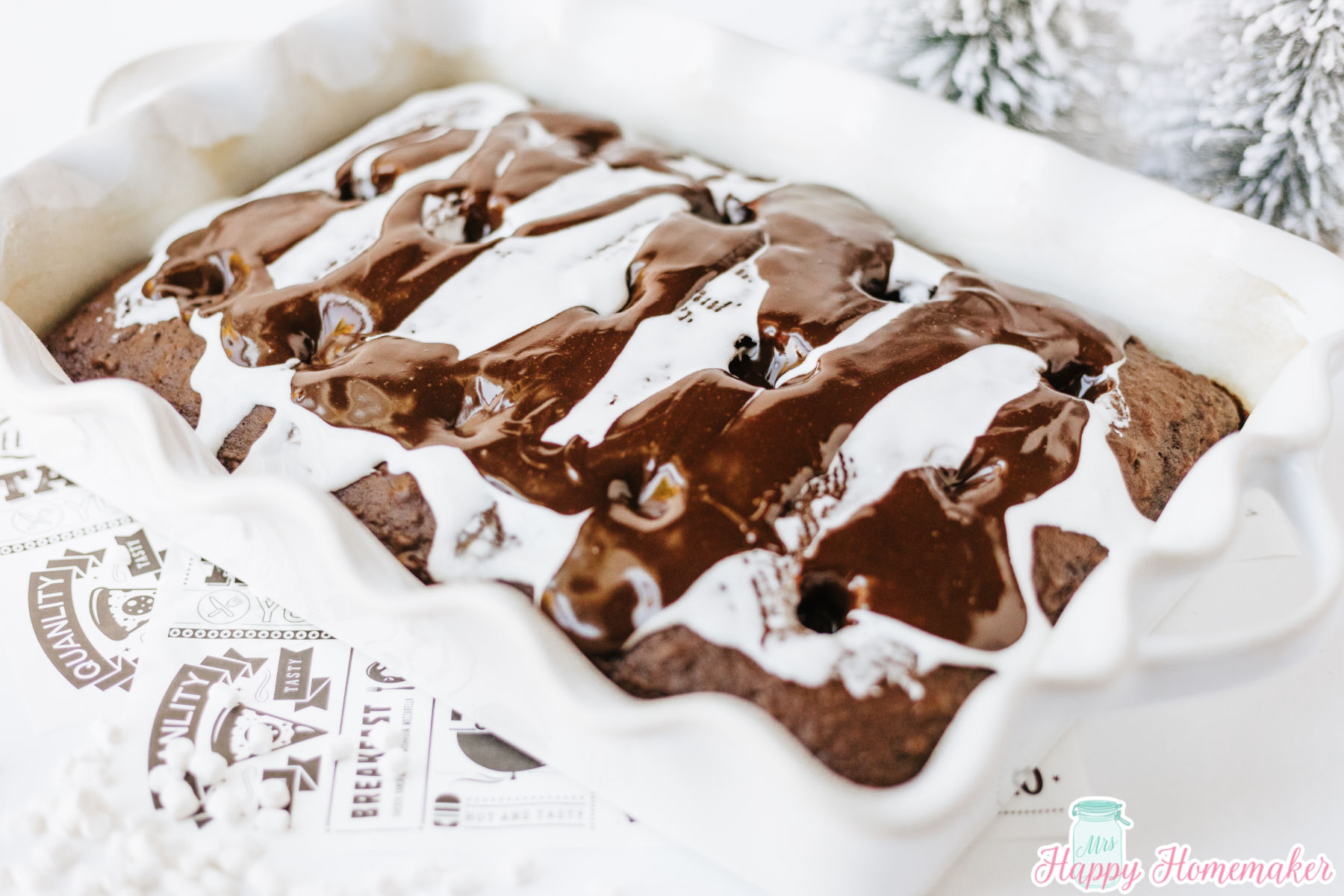 chocolate sauce being poured over chocolate poke cake