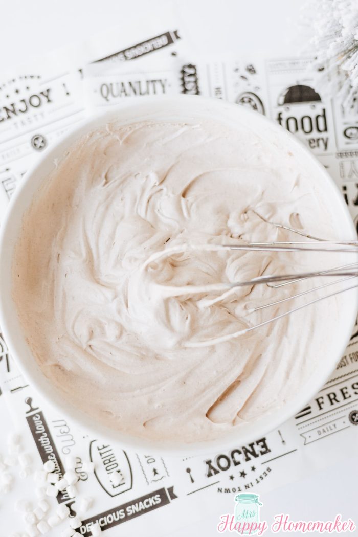 cool whip and hot cocoa mix whipped into frosting in a bowl
