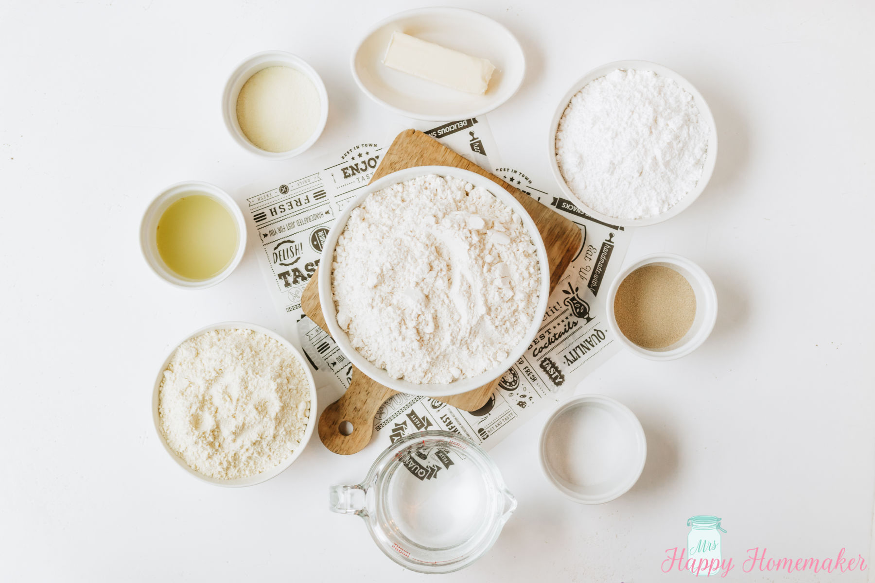 the ingredients for lemon rolls in individual ramekins spread out on a white counter