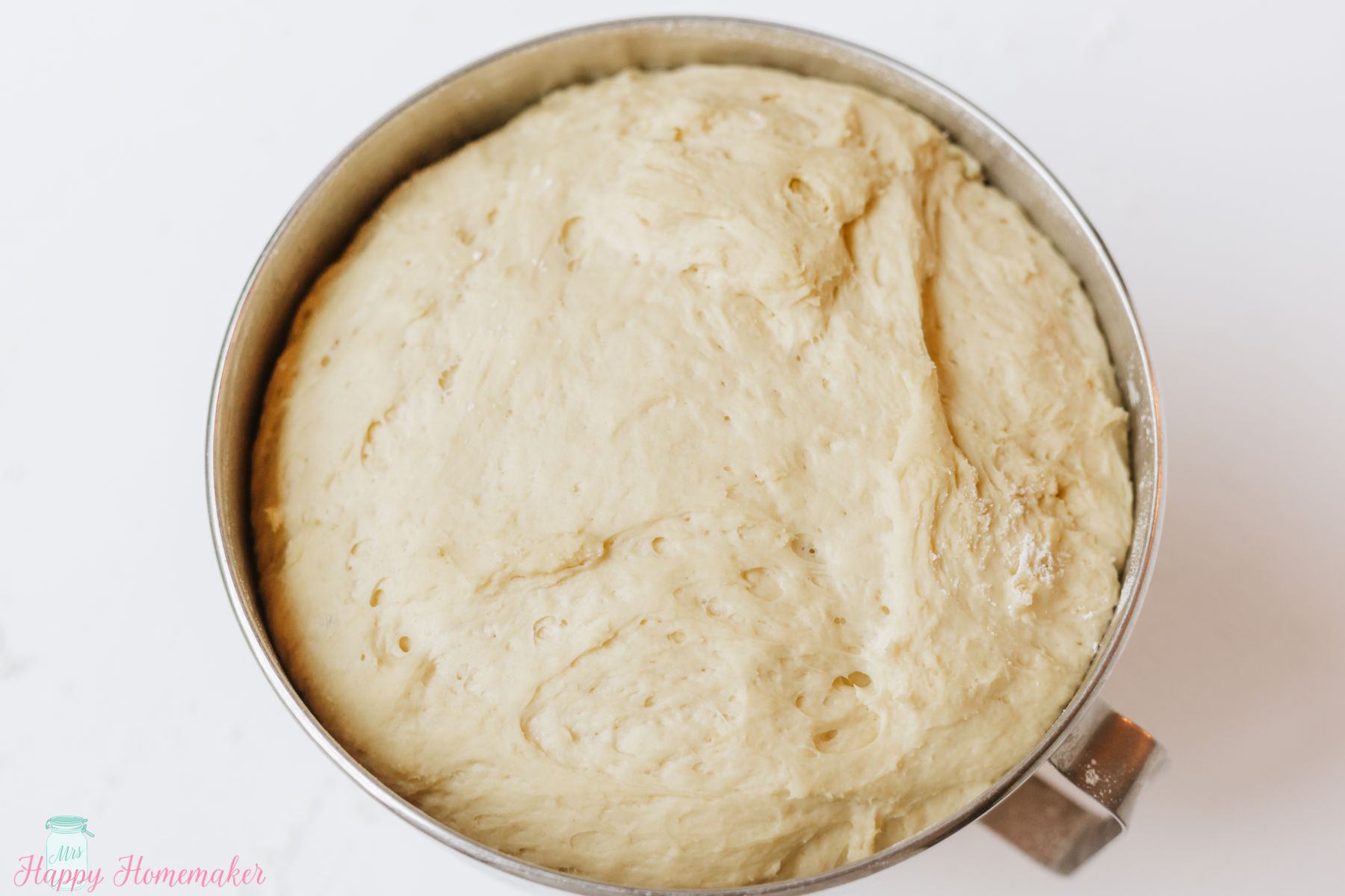 dough for the lemon rolls in a mixing bowl after rising