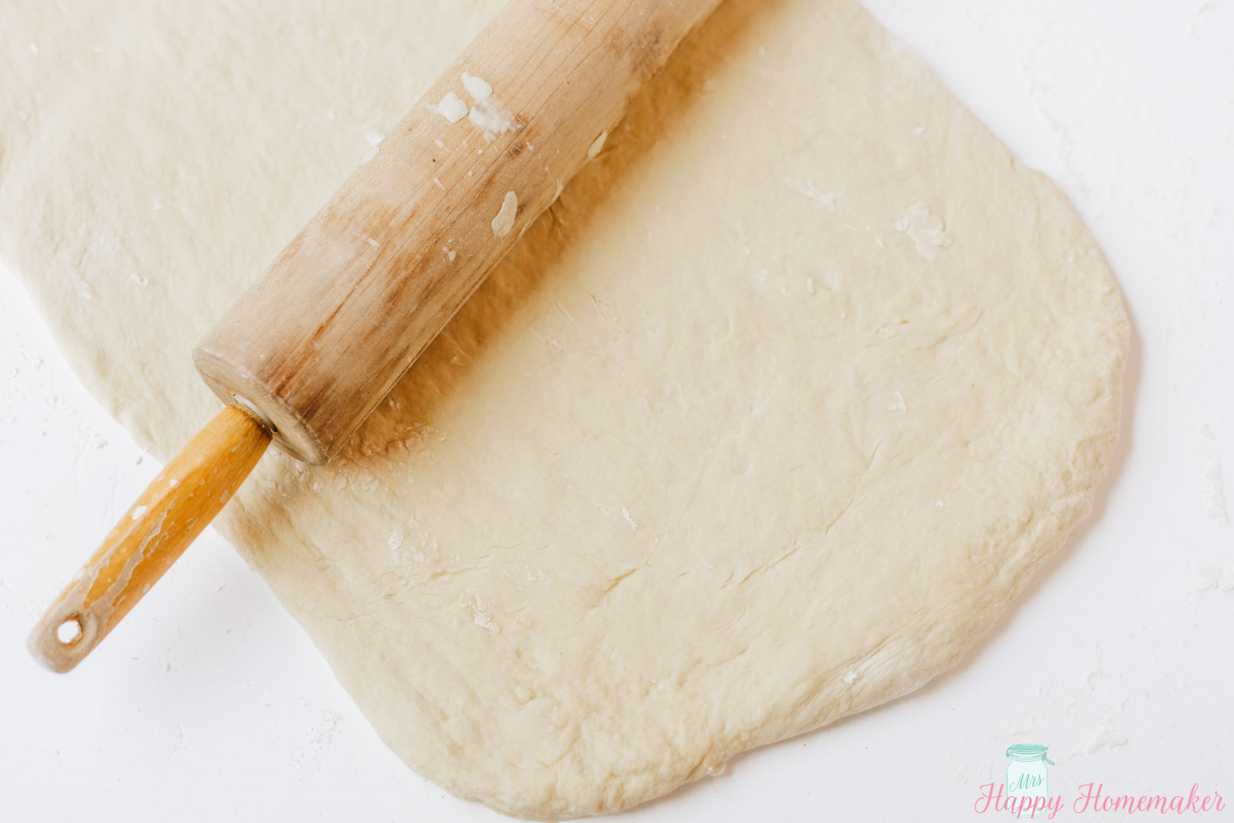 Lemon Roll dough being rolled out with a rolling pin