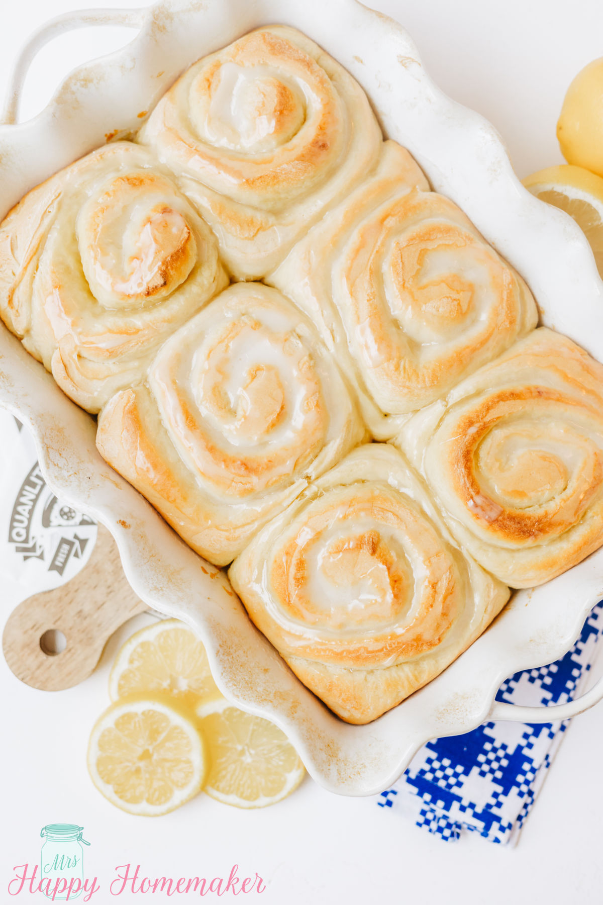 Iced Lemon Rolls in a white ruffled 9x13 baking dish