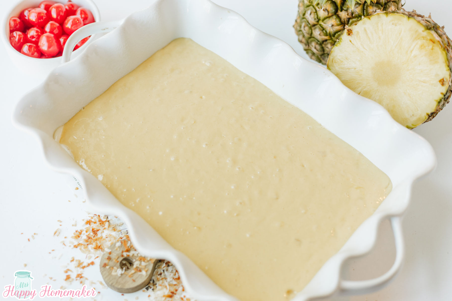 Simple & Easy Pina Colada Poke Cake - raw batter in a white rectangle casserole dish