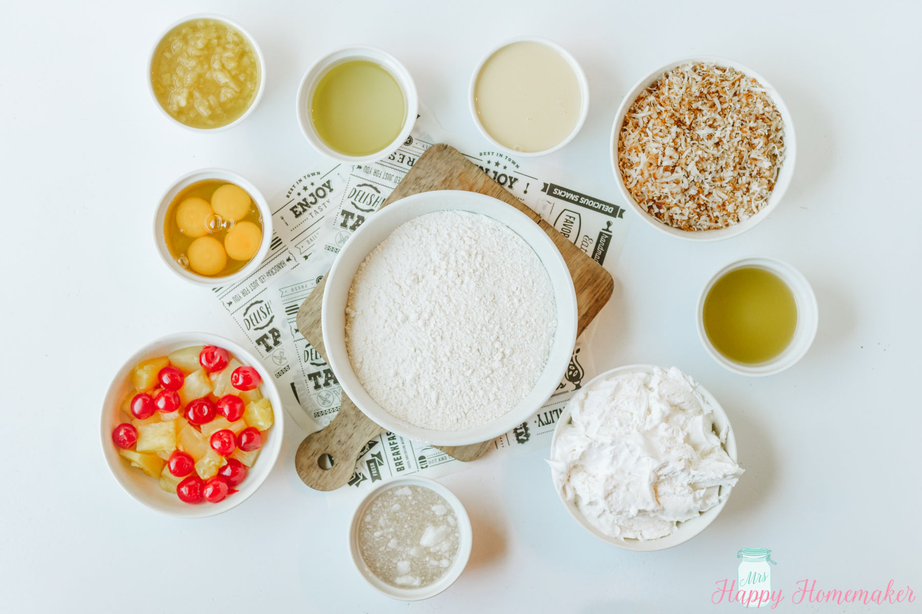 Simple & Easy Pina Colada Poke Cake ingredients laid out in small dishes on a white countertop