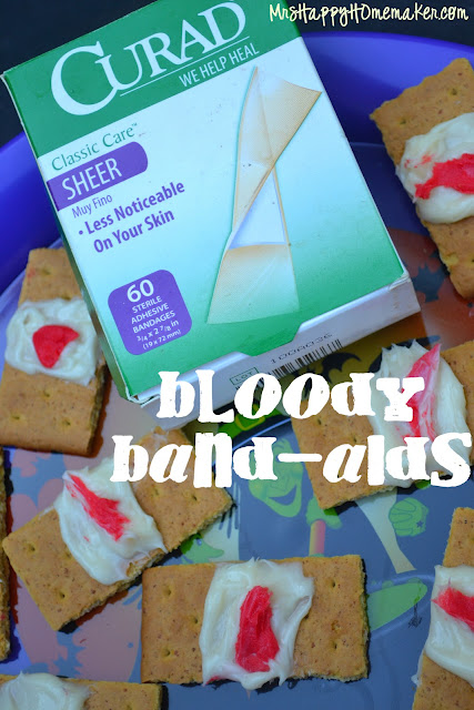 Blood Band Aid graham cracker cookies made from graham crackers, frosting, and red icing