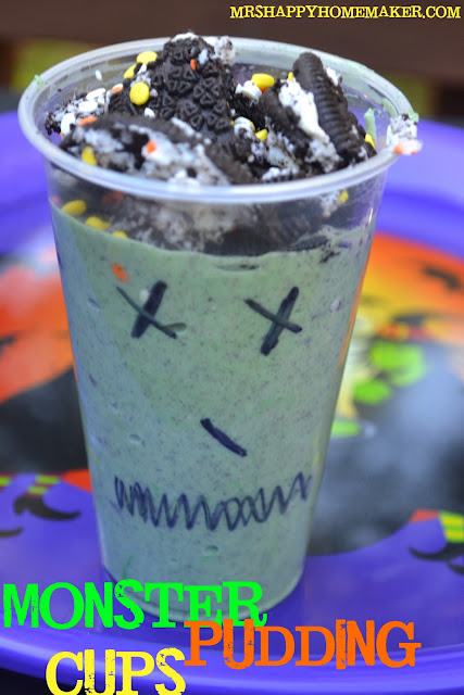 Monster Pudding Cups - green pudding topped with Oreos with clear plastic cups decorated with a black sharpie 
