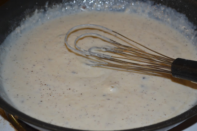 gravy being whisked in a skillet 