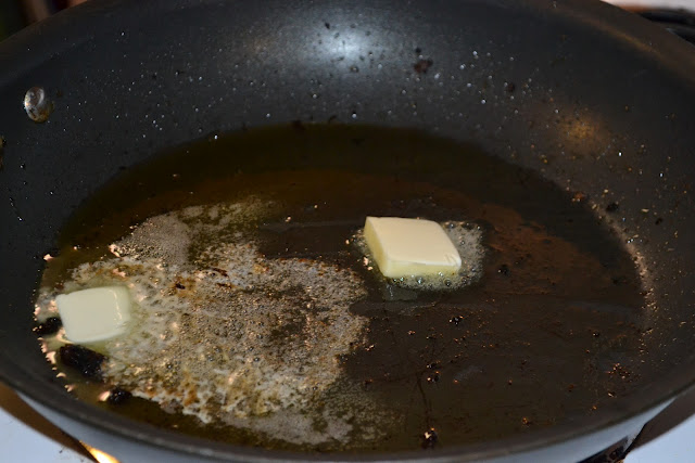 melting butter and sausage grease in a black skillet