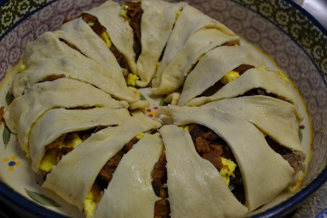 Unbaked breakfast crescent roll ring in a round casserole dish 