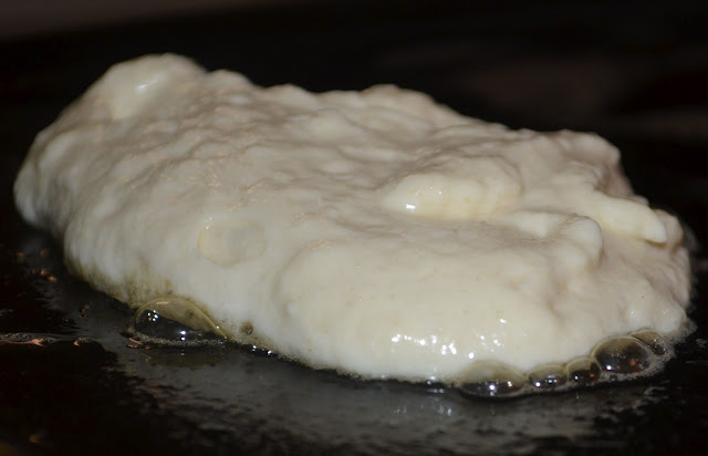 cooking a pancake on a hot buttered skillet