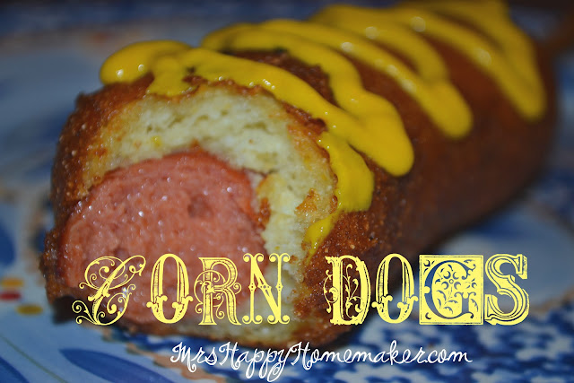 Corn dog with a bite taken out of it and mustard on top