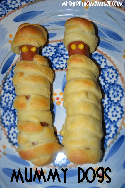 Mummy wrapped hot dogs with mustard dot eyes