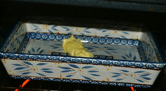 butter melting in a casserole dish in the oven 