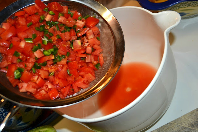 tomatoes draining for salsa in a colander 
