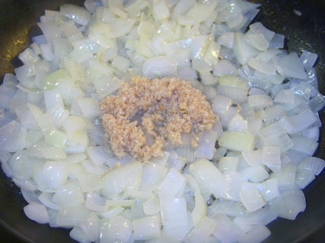 Onions and garlic cooking in a skillet