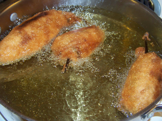 Frying Chiles Rellenos in a skillet of oil